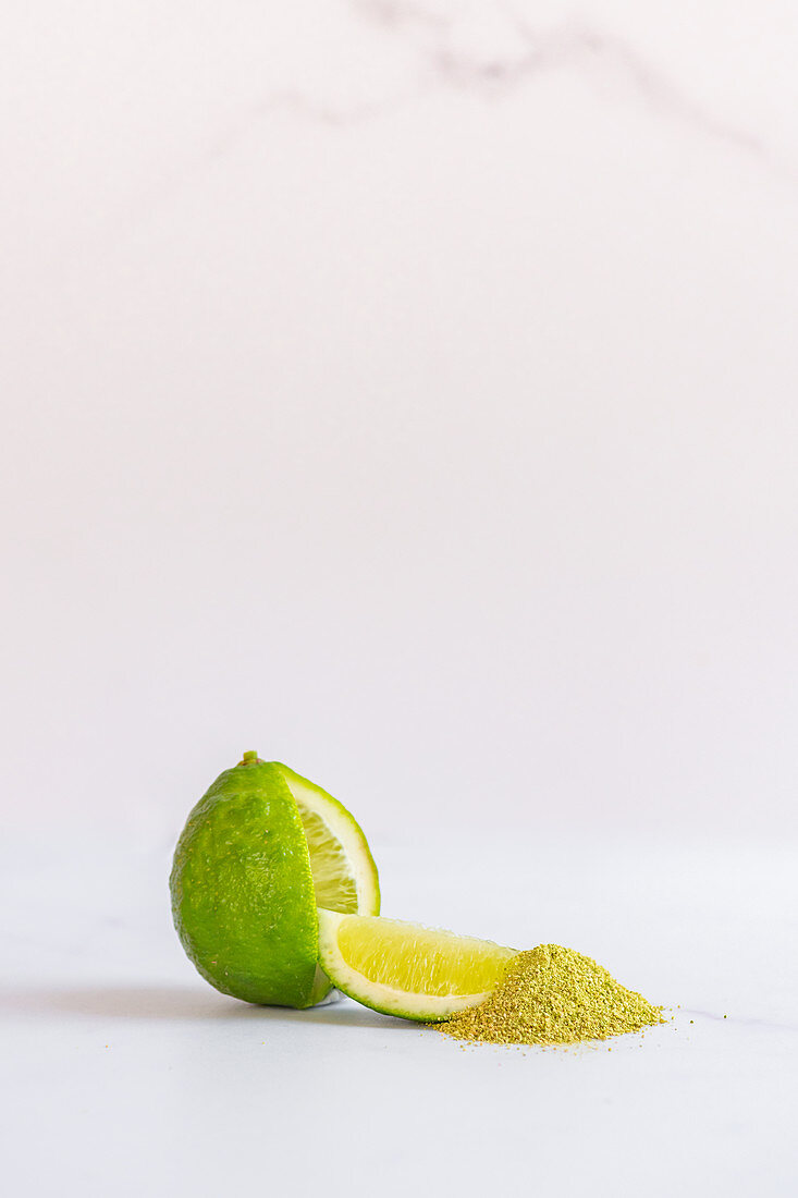 Lime with wedge and lime fruit powder
