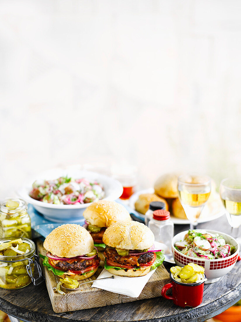 Grilled burgers with gherkins and salad