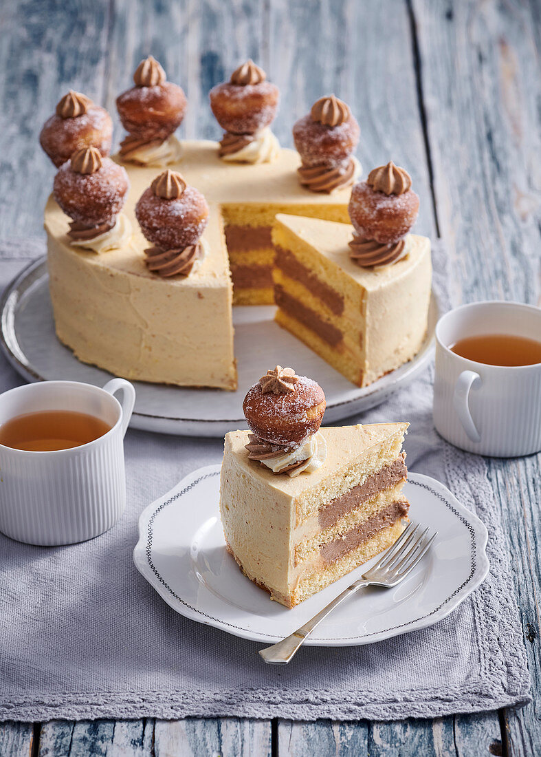 Cake (gateau) with caramel cream and small douhnuts