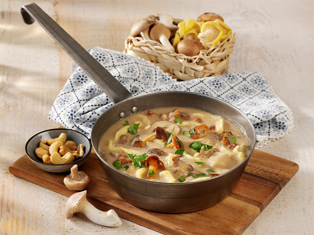 Mushroom and noodle stew with bacon and cashew nuts