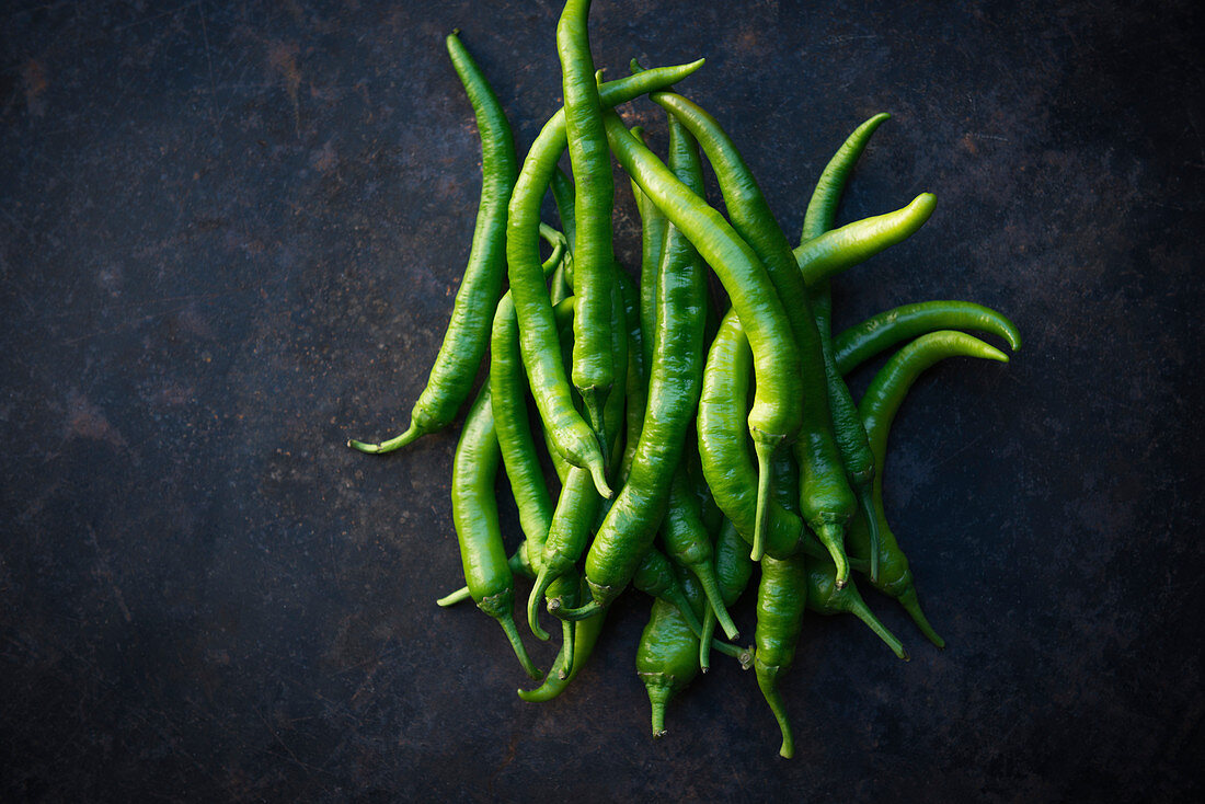 Green peppers on a dark background