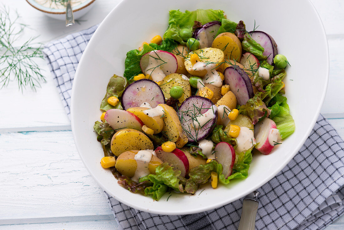 Potato salad with radishes, lettuce and vegan yogurt dressing