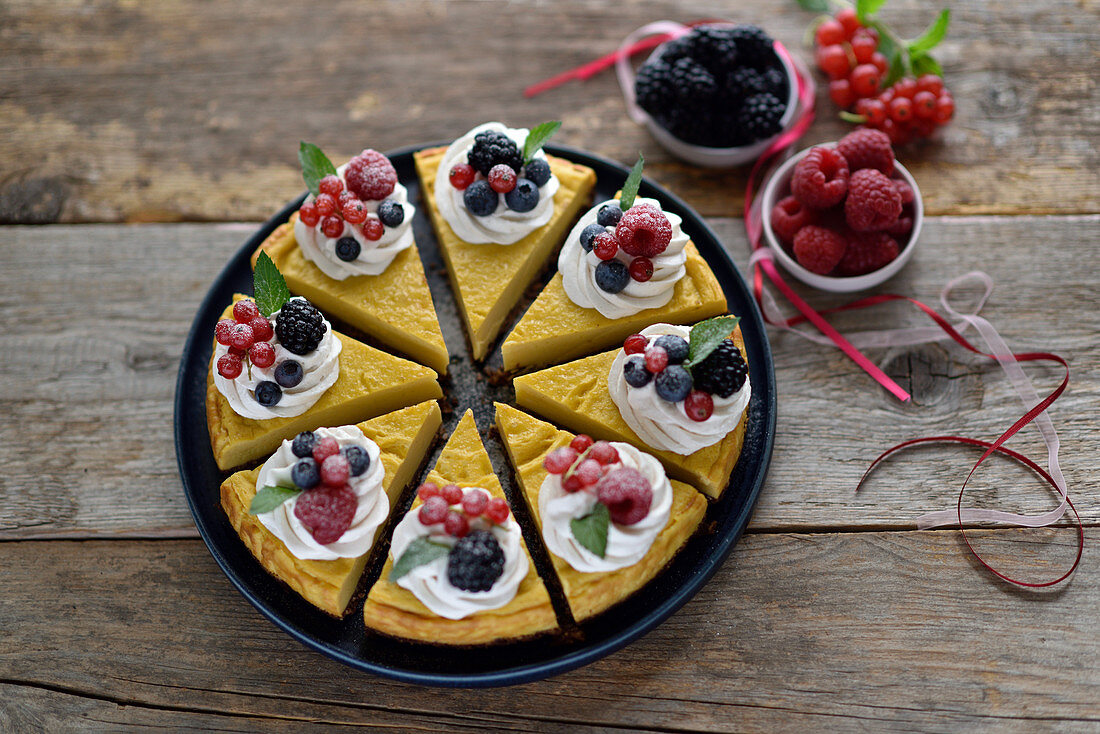 Vegan mango cheesecake with chocolate oatmeal base and berries