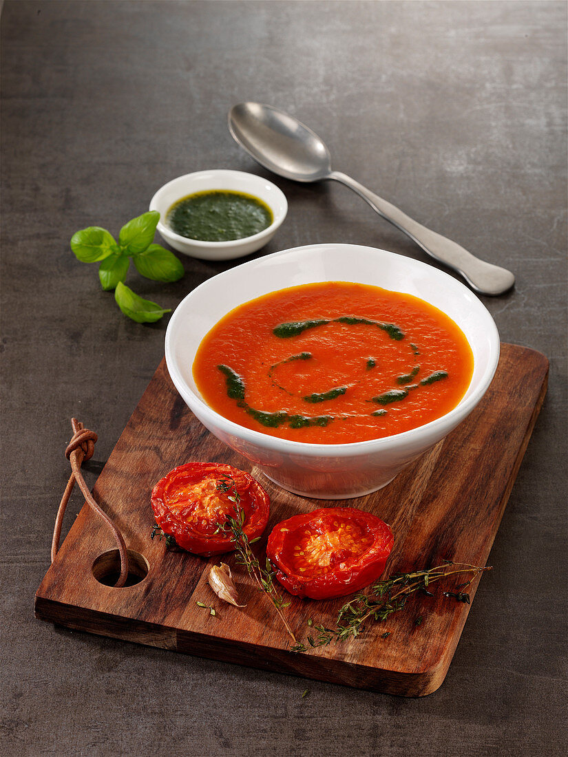 Vegan stewed tomato soup with basil and garlic oil