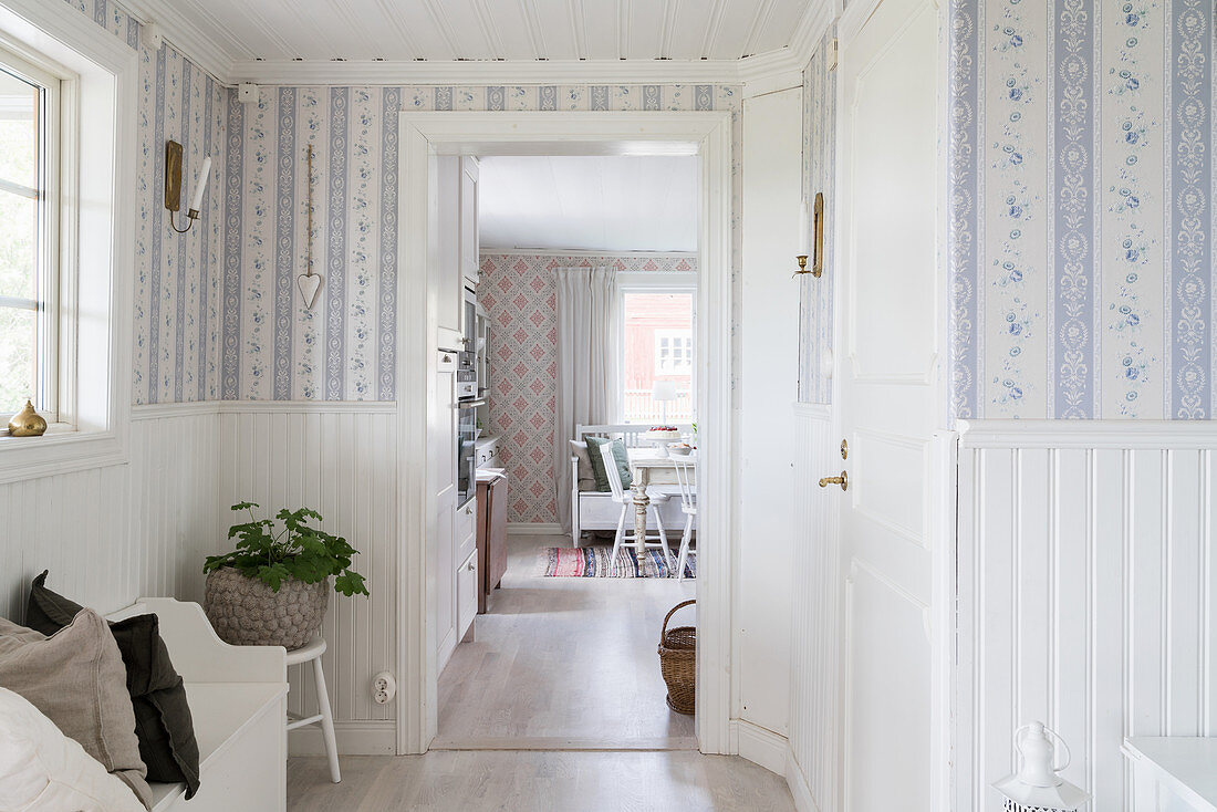 Foyer with white wainscoting and pretty wallpaper