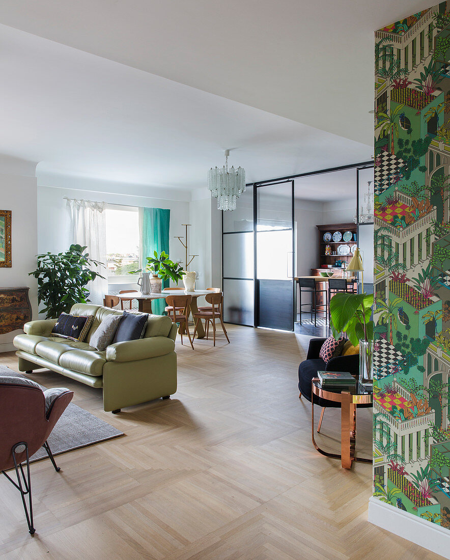 Open-plan, eclectic interior with parquet floor and sliding doors