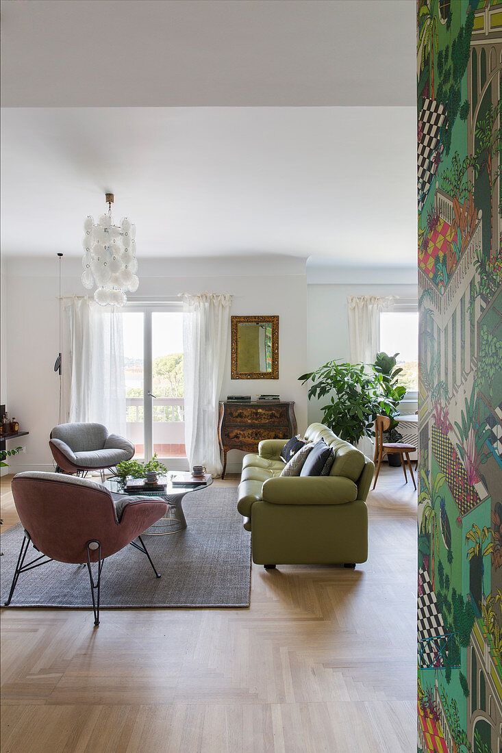 Green leather sofa in open-plan classic living room