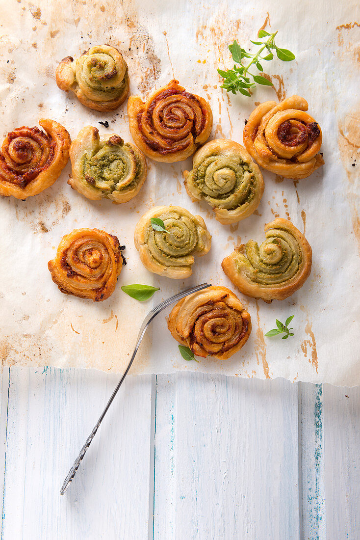 Vegan puff pastry spirals filled with red and green pesto