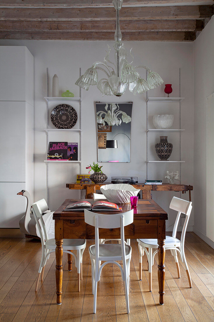 Antique chandelier above wooden table in dining room