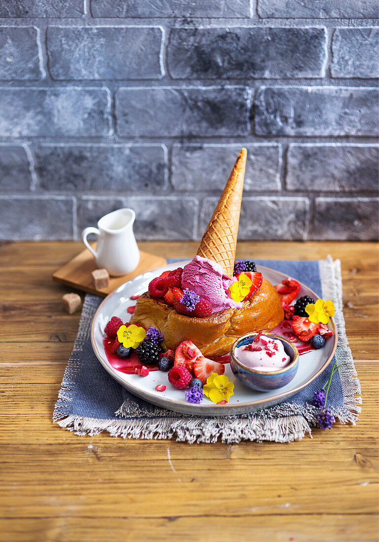 Berry brioche French toast with ice cream and edible flowers