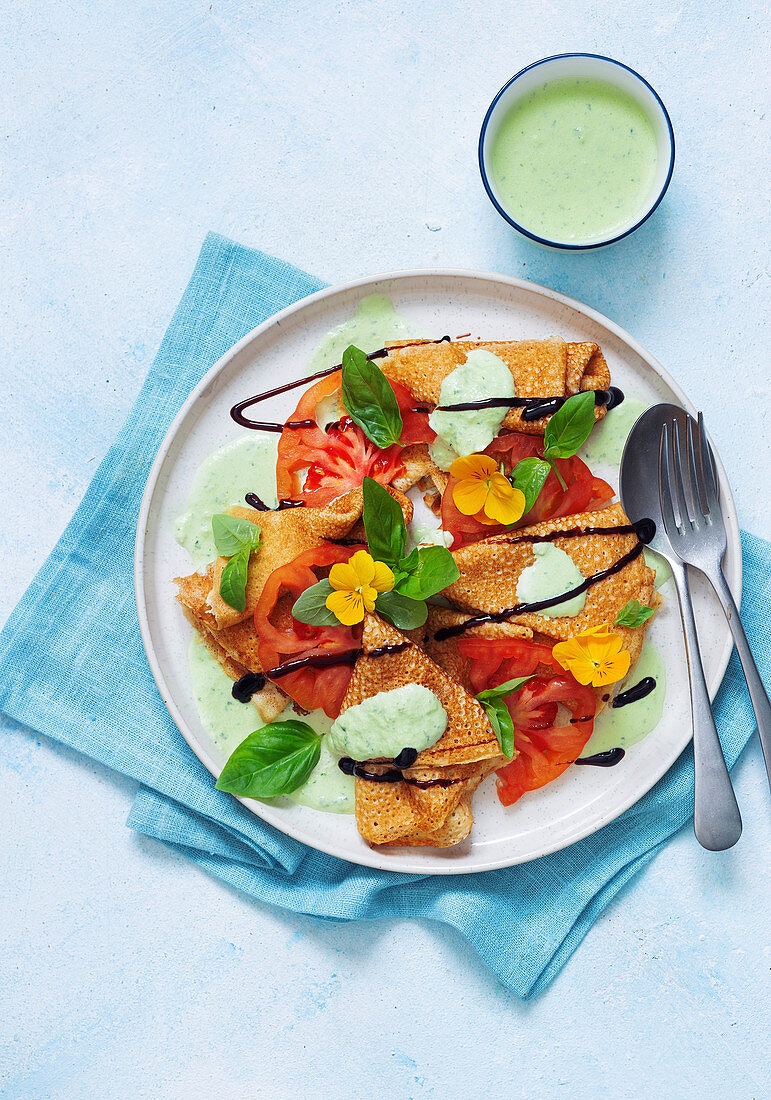 Tomato crepes with mozzarella cream and edible flowers