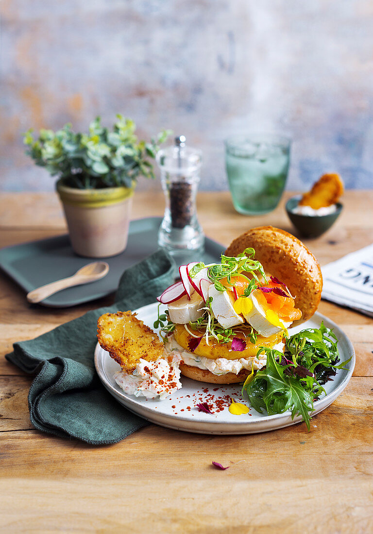 A triple cheese bagel with smoked salmon and radishes