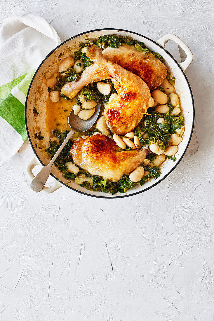Chicken legs with pesto, butter beans and kale