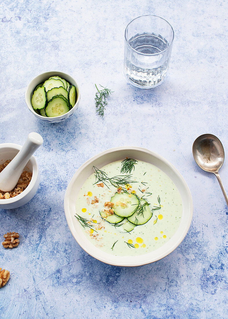 Cold cucumber and dill soup named Tarator on rustic table