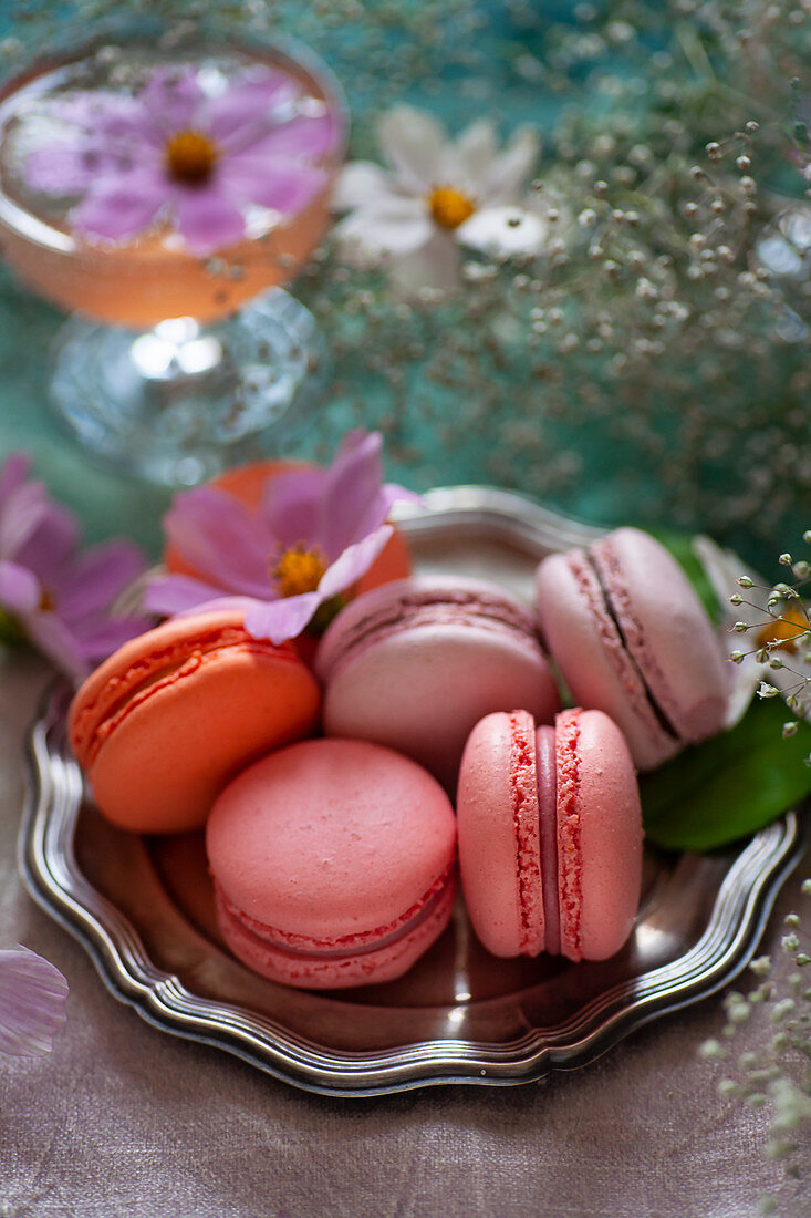 Different colored macarons on a silver plate
