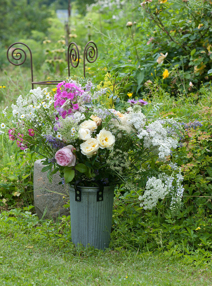 Rural bouquet with roses, Toothpick Weed (Amni visnaga), flame flower, goat's rue and daisy fleabane