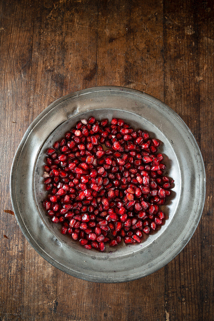 Pomegranate seeds in a metal plate