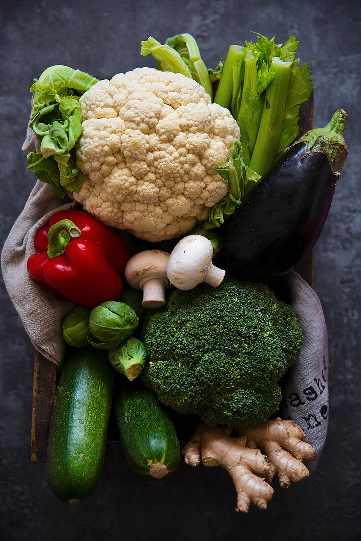 Box of fresh vegetables - cauliflower, broccoli, celery, zucchini, eggplant, mushrooms and red pepper