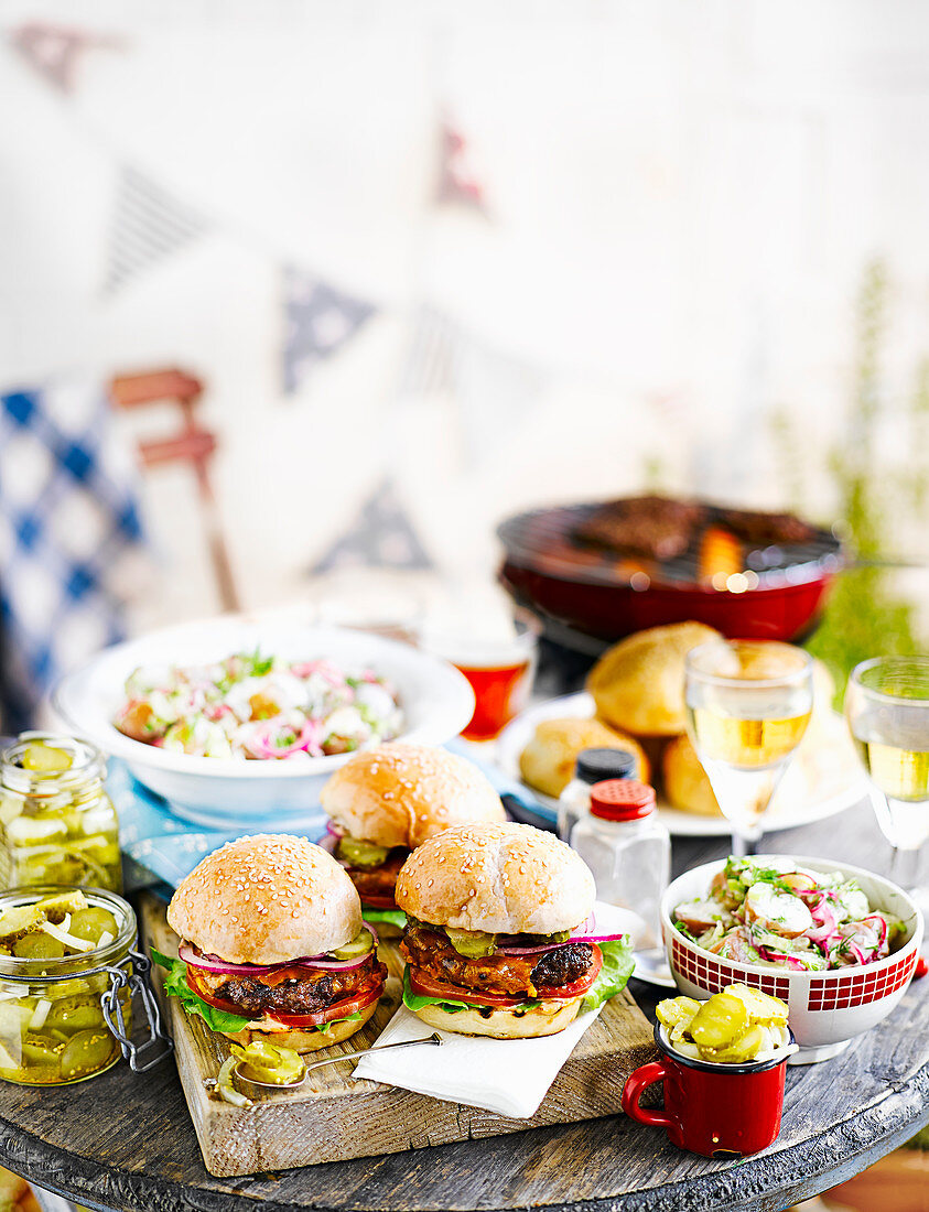 Burgers with pickles and lettuce for a barbecue party