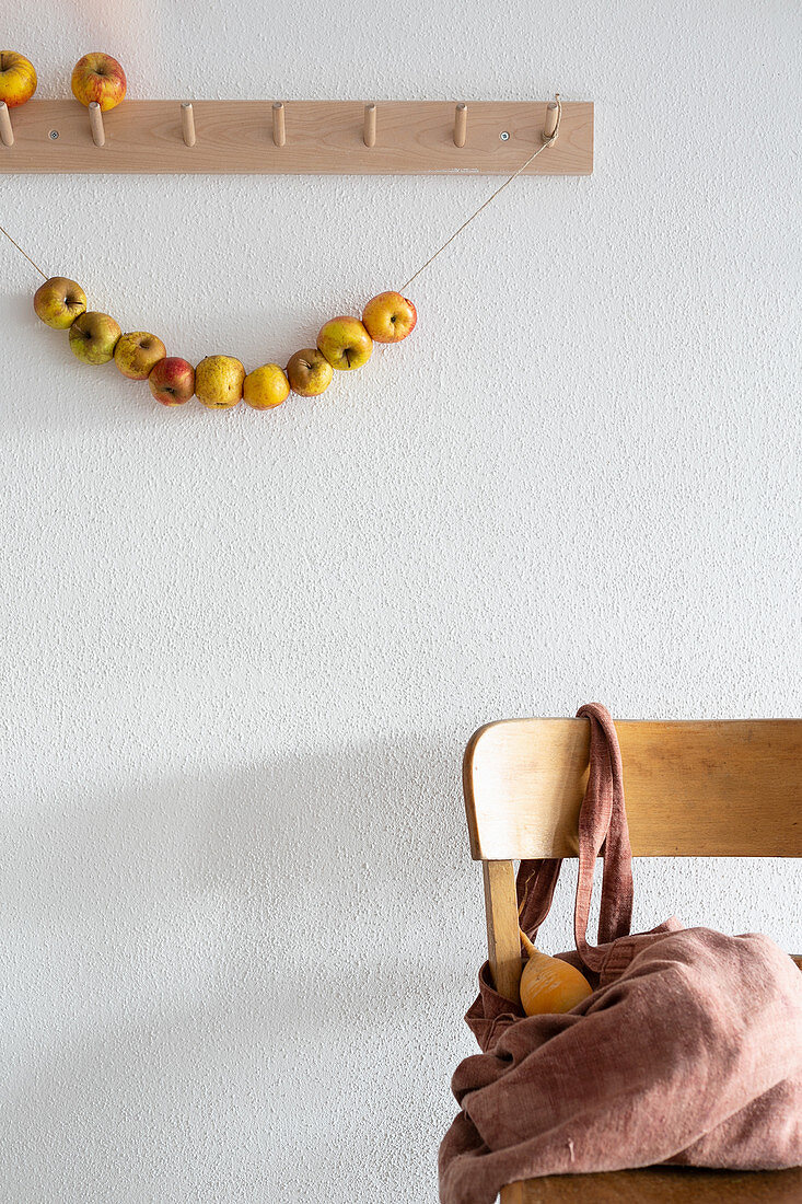 Garland of apples hung from coat rack