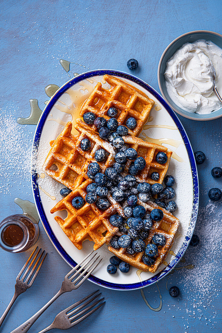 Homemade waffles with honey, blueberries and greek yoghurt