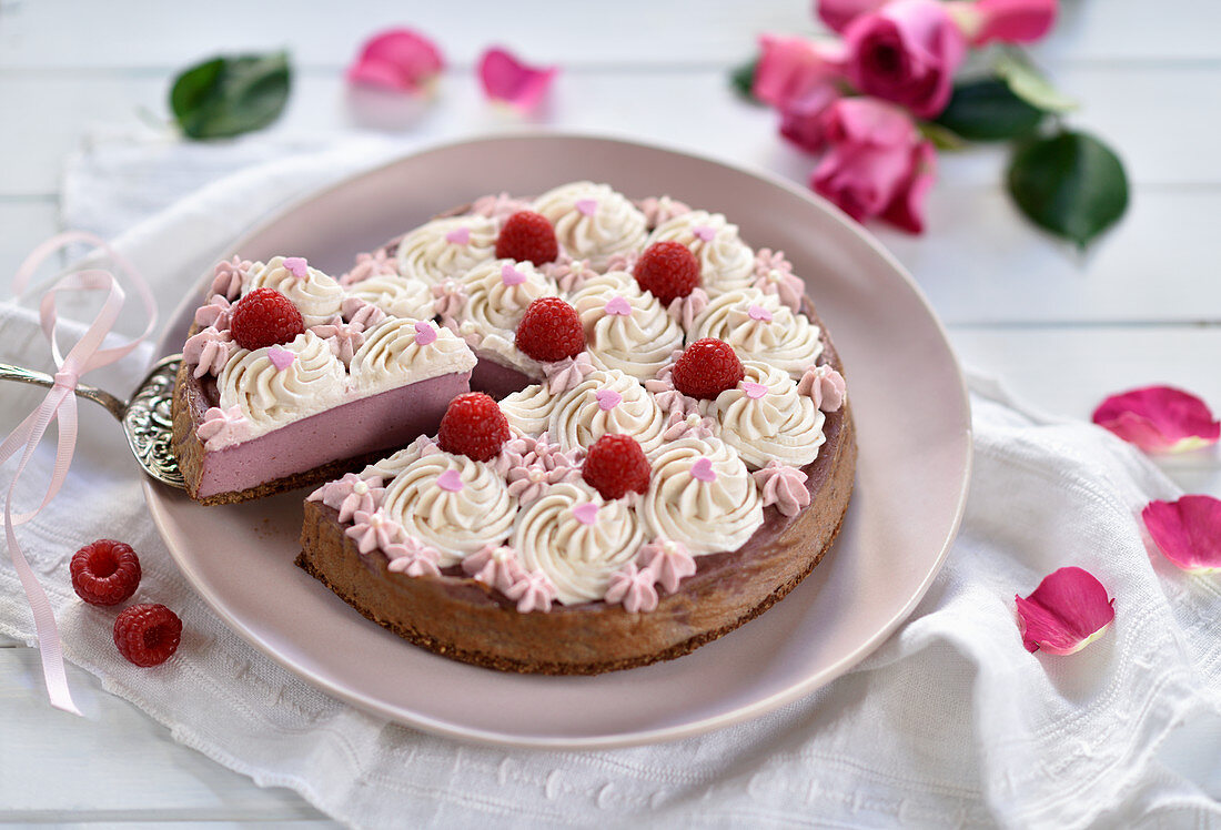 Vegan raspberry cheesecake with chocolate shortcake and piped cream