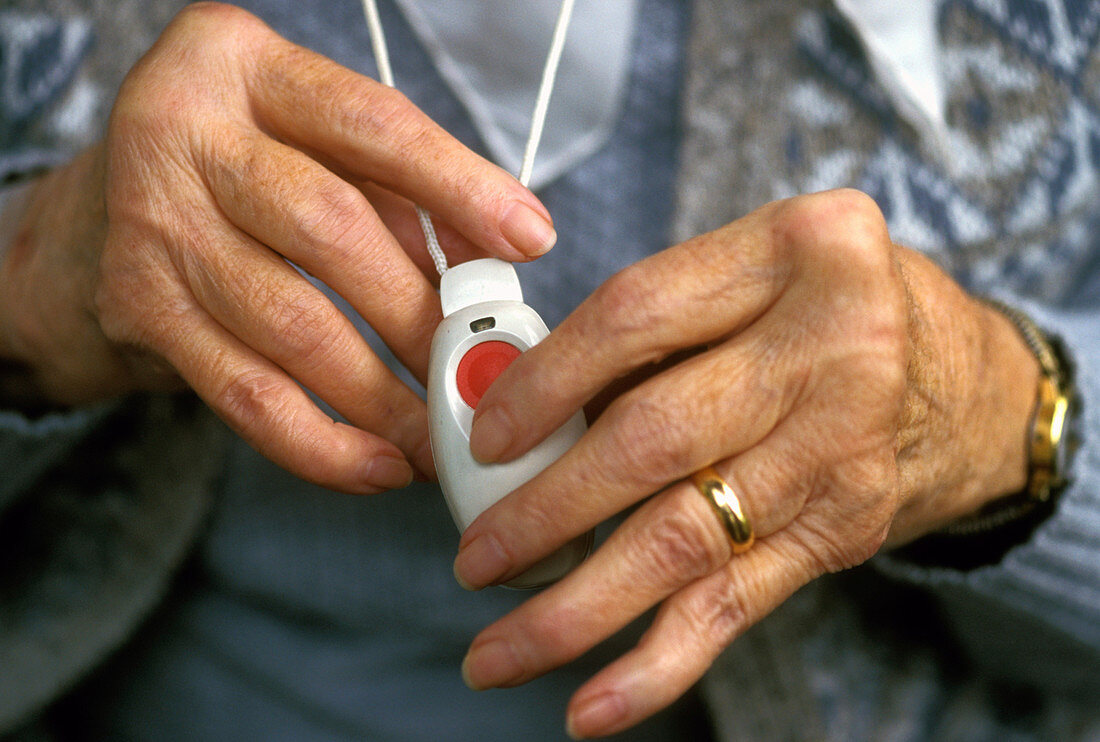 Elderly woman holding panic alarm