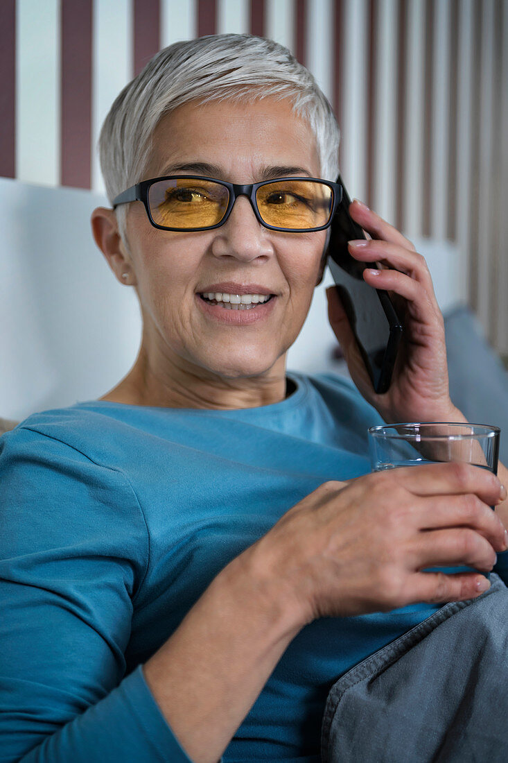 Mature woman wearing blue light blocking glasses