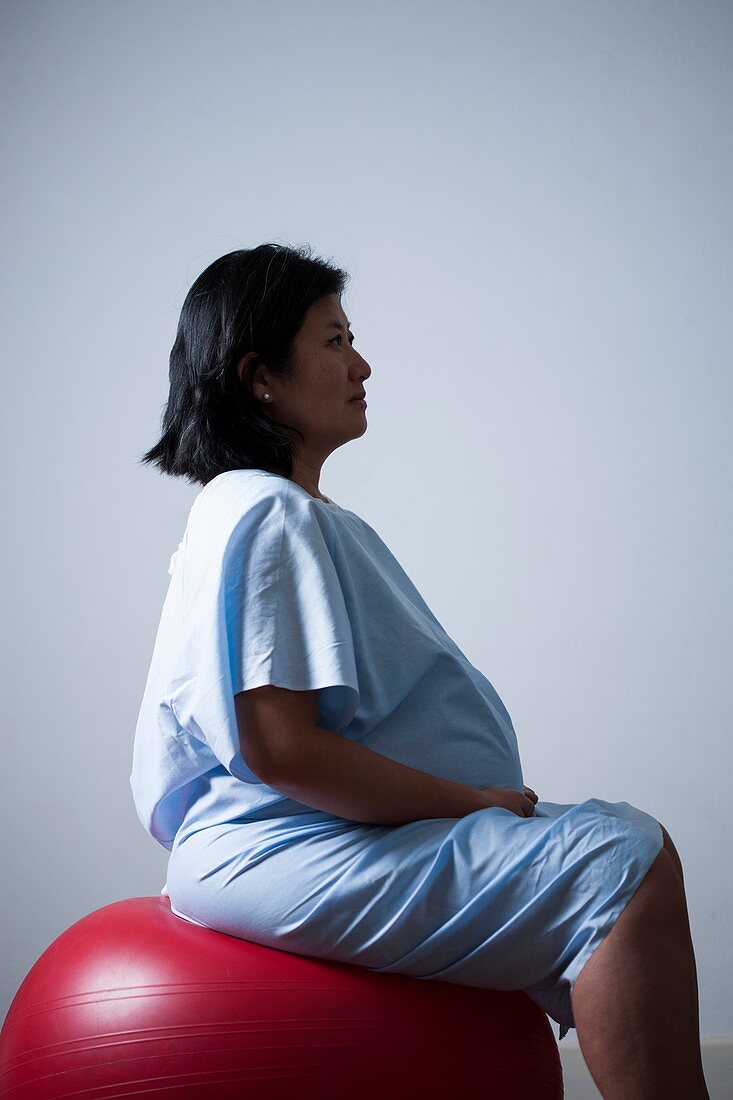 Pregnant woman sitting on birthing ball