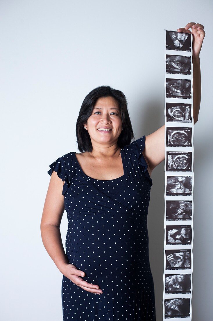 Pregnant woman holding baby scans