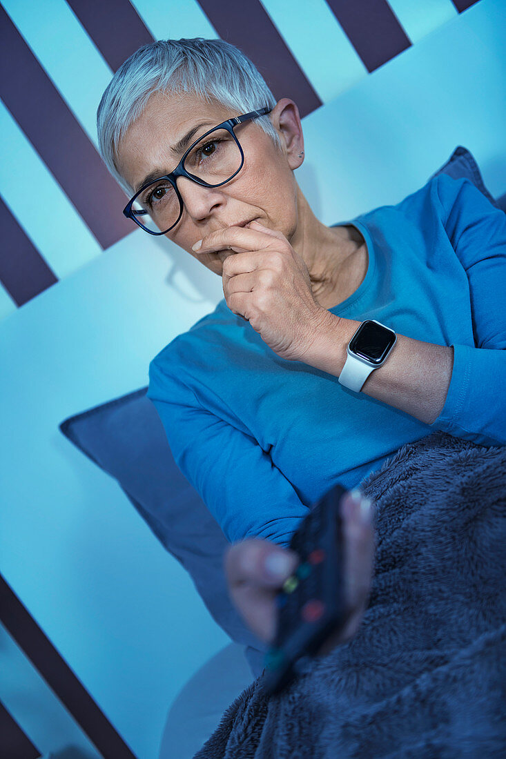 Woman with insomnia watching television