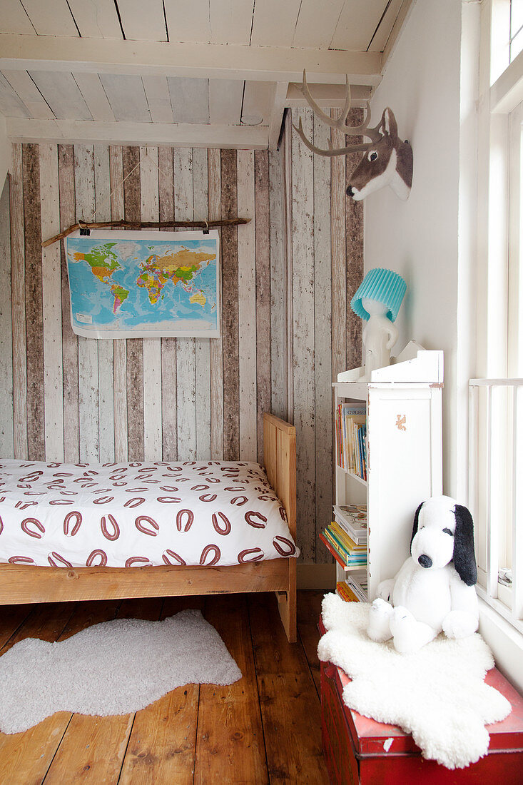 Wooden bed and wood-clad wall in child's bedroom