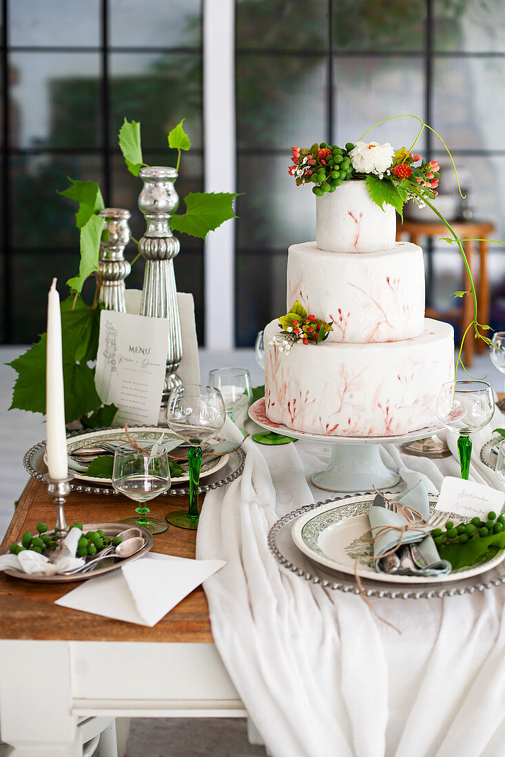 A three-tier cake on a festively laid table