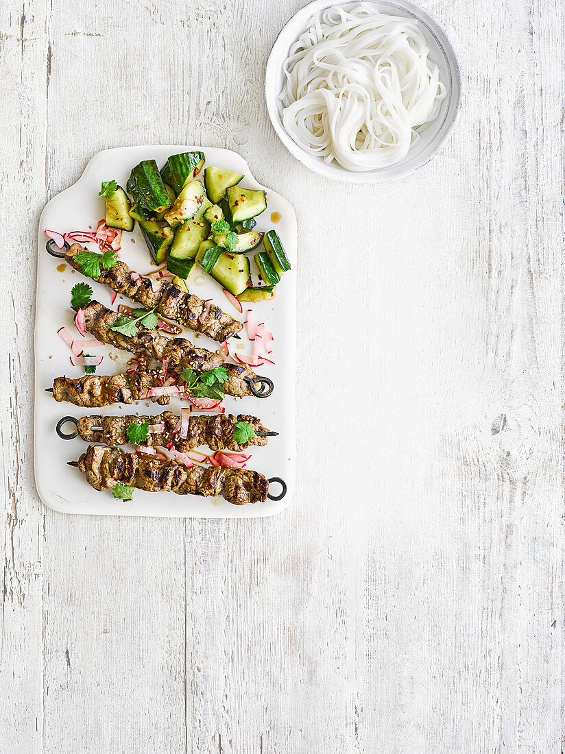 Ribbon beef skewers with radish pickles and smashed cucumber