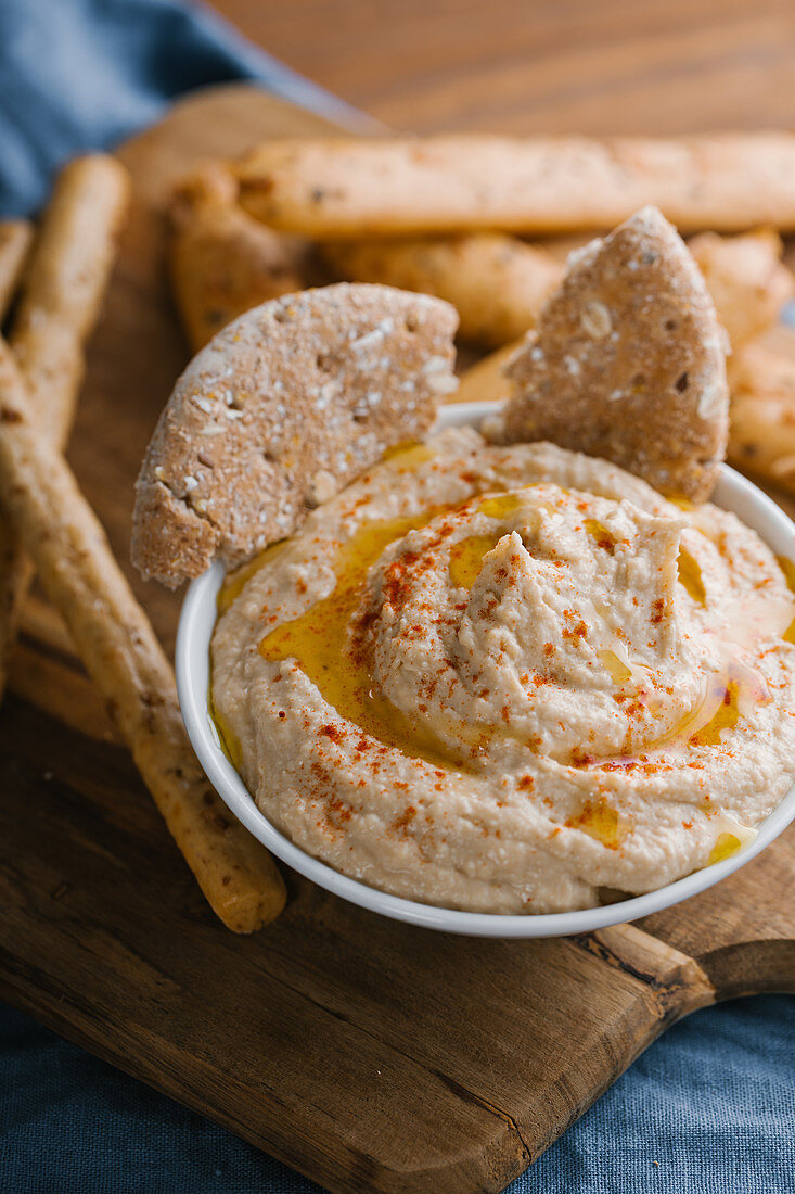 Delicious homemade hummus with paprika, seeds and olive oil