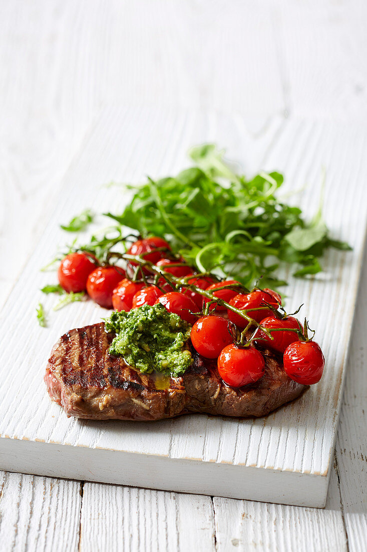 Pesto steak with balsamic tomatoes