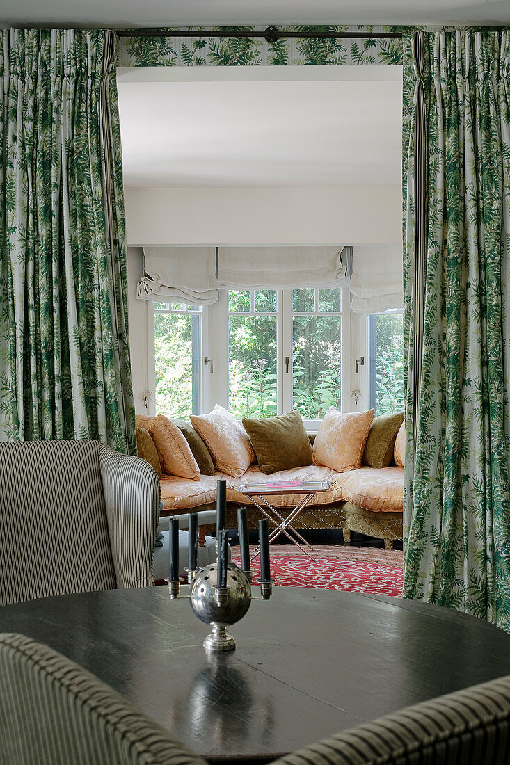 View past silver candelabra on round table to leather couch