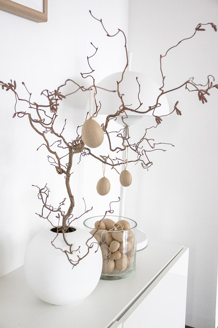 Twig decorated with papier-mâché eggs