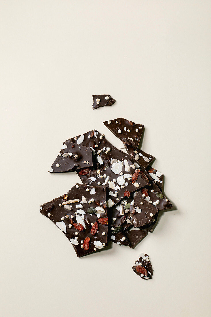 Handmade chopped dark chocolate with different superfood additives seeds and goji berries