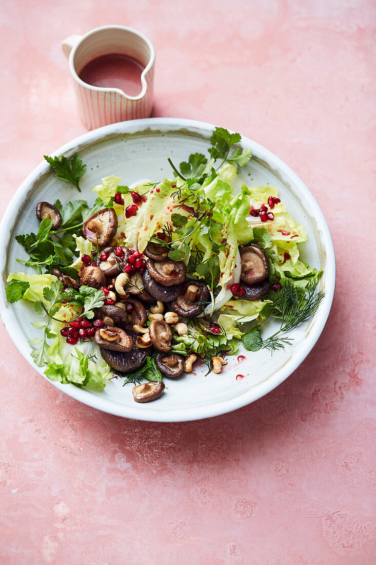Chicory salad with mint, shiitake mushrooms, pomegranate seeds and redcurrant dressing