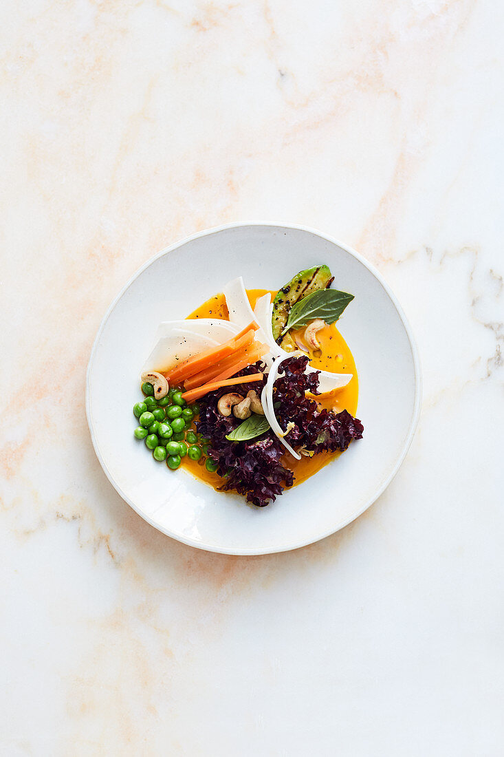 Lollo rosso with peas, ginger and a carrot dressing