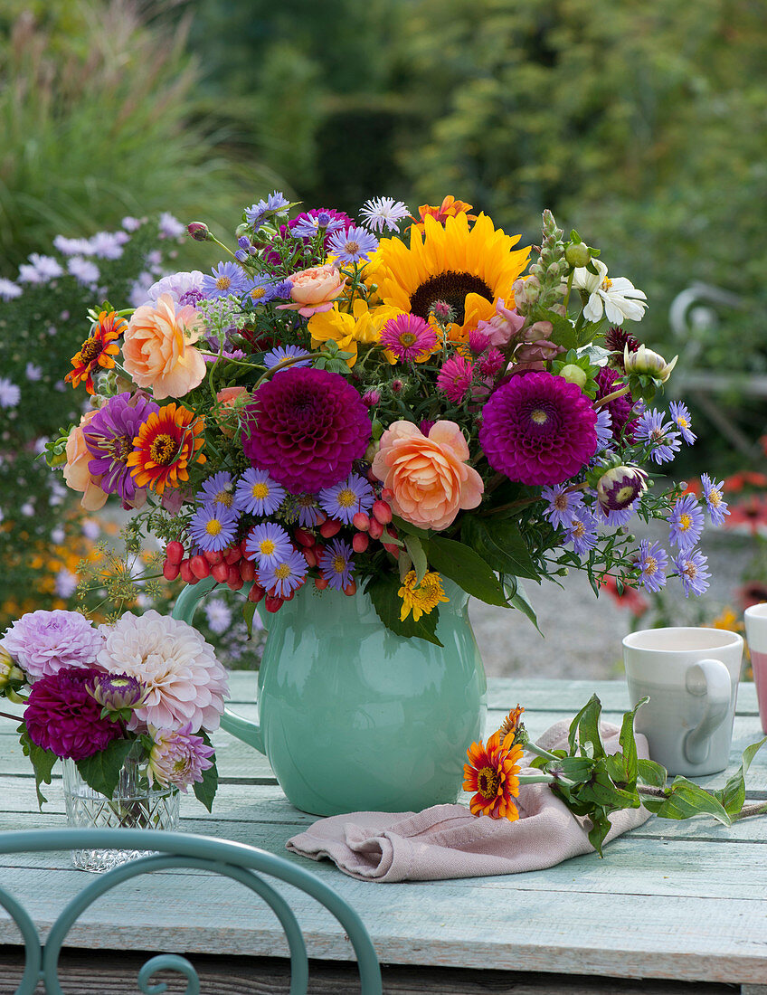 Late summer bouquet with dahlias, roses, sunflower, zinnias, aster, ornamental apples, cartilaginous carrots, snapdragons and fennel umbels