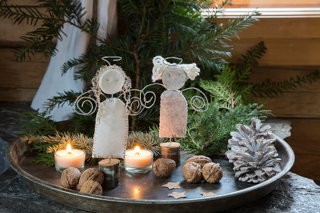 Handmade wire and felt angels and natural decorations on tray