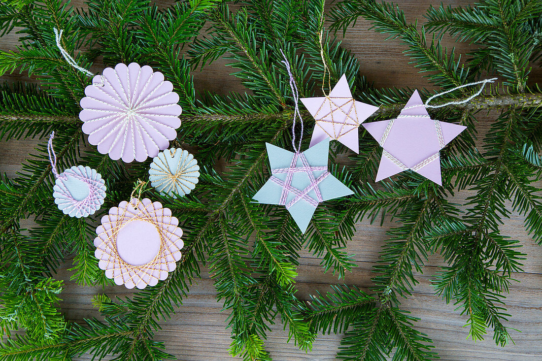 Christmas-tree decorations handmade from paper and yarn