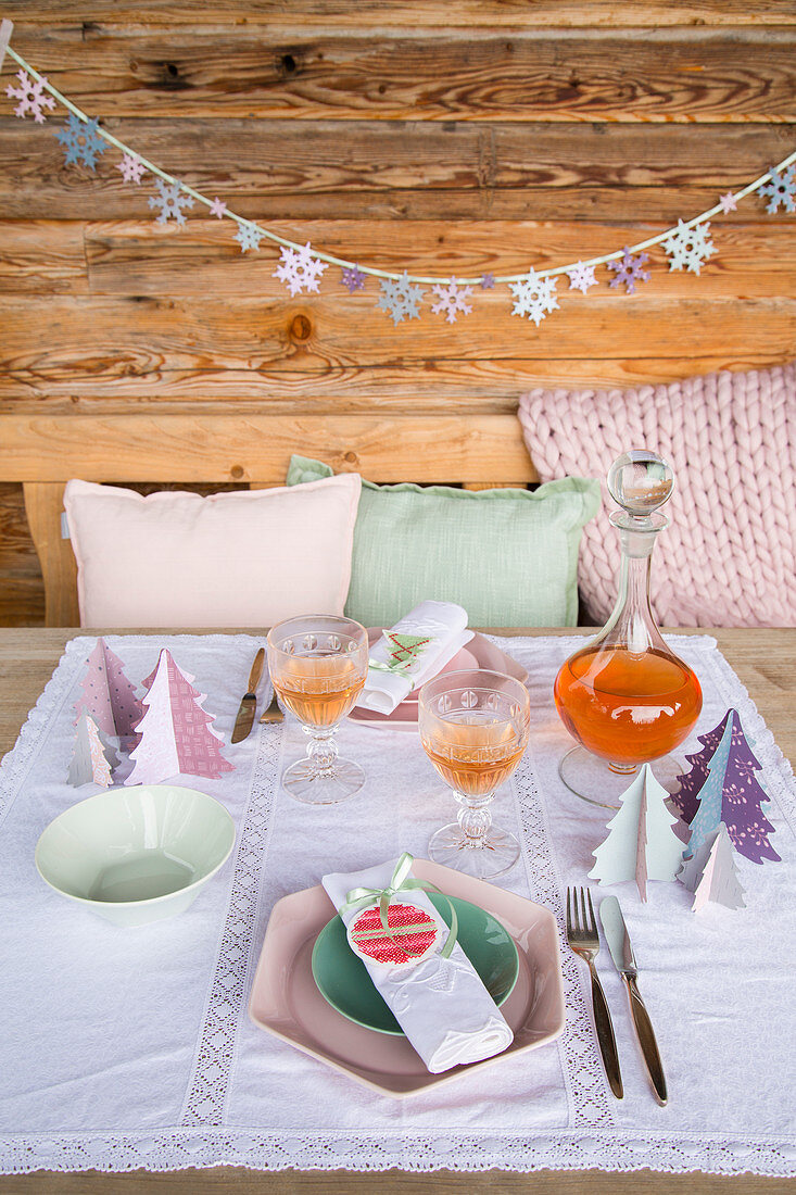 Festively set table decorated with handmade decorations in pastel shades