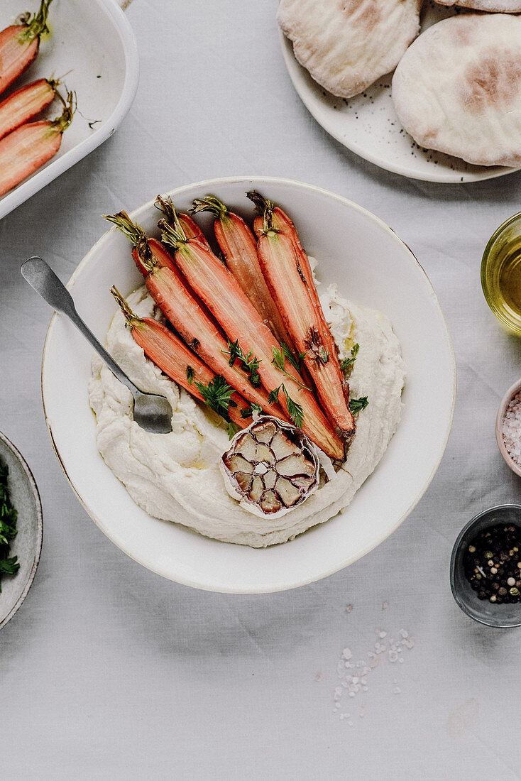 Hummus with roasted carrots pitta bread and garlic