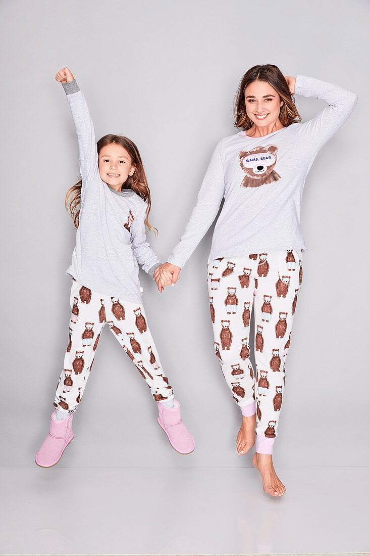 A mother and daughter wearing matching pyjamas