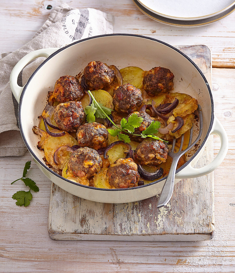 Beef meatballs with chorizo and cheese on a bed of potatoes