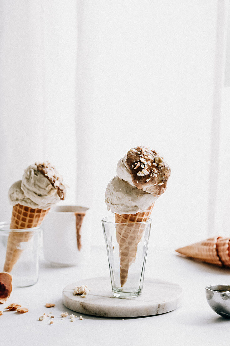 Ice cream in a cone with salted caramel and nuts