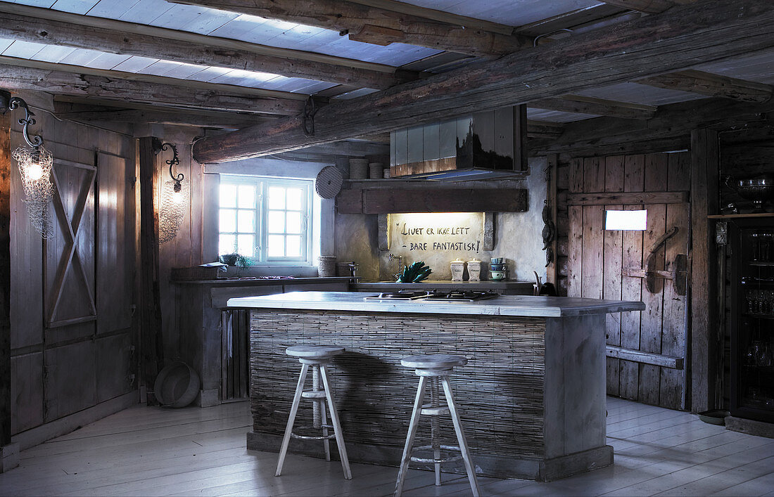 Island counter in rustic kitchen in old wooden house
